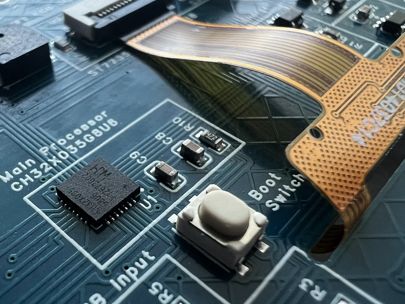 Macro photograph of the CHGame board showing the CH32X035G8U6 processor, the boot switch and the display ribbon cable, each named in white silkscreen.